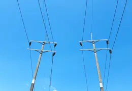 Electrical transmission towers with distribution lines